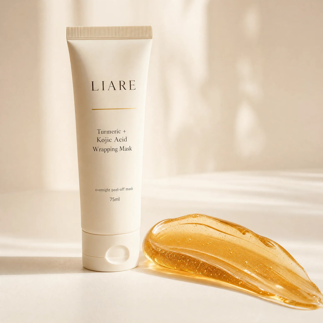 Turmeric and kojic acid overnight wrapping mask tube on a bathroom counter beside a peeled mask sheet