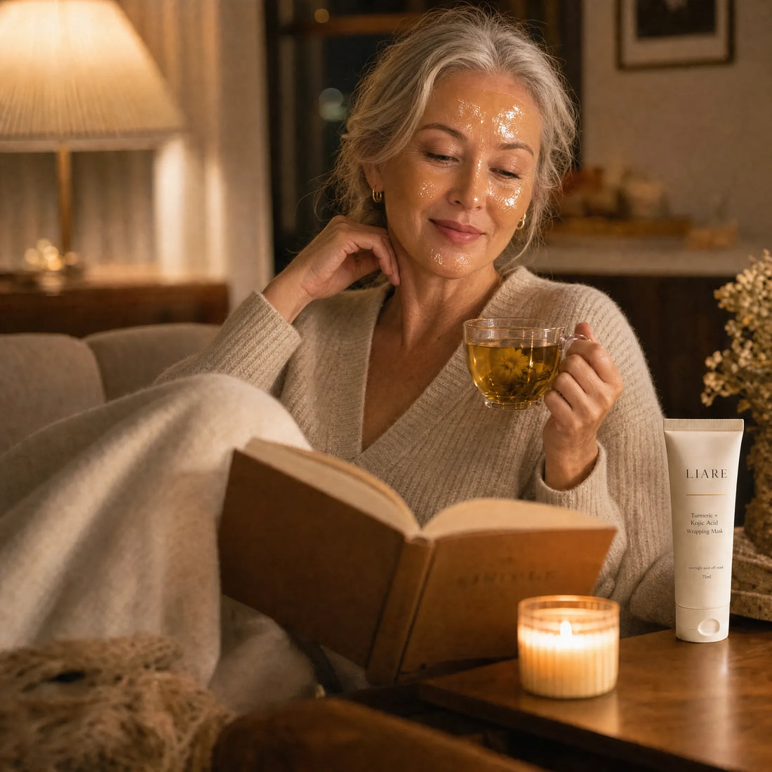 Woman smiling at her reflection in morning light after peeling off the overnight mask